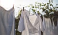 Clean laundry hanging to dry outside in the summer sun on a clothes line.