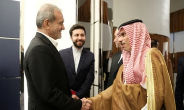 Iran's president Masoud Pezeshkian shaking the hand of Saudi Arabia’s foreign minister Prince Faisal bin Farhan Al Saud