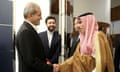 Iran's president Masoud Pezeshkian shaking the hand of Saudi Arabia’s foreign minister Prince Faisal bin Farhan Al Saud