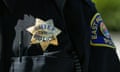 a police badge on a uniform reads 'chief police East Palo Alto'