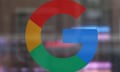 Google logo, a multicolored G, on a glass storefront