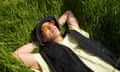 A man relaxes on grass outside