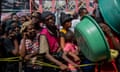 People wait for a food distribution in a displaced persons camp at the Lycée Marie Jeanne in Port-au-Prince on 30 September 2024