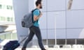 Young man walking with suitcase