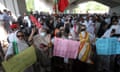 People under a motorway bridge holding flags and placards demanding the release of Imran Khan and  'our abducted chief minister'