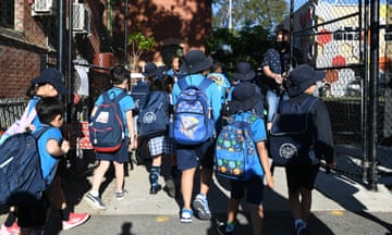 primary school children entering the school gate