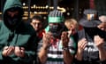 People wearing keffiyehs and the colors of the Palestinian flag gather to pray outside