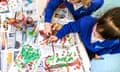 Young children painting during an art lesson in a reception class