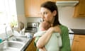 Woman alone with baby in kitchen