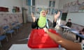 Woman raises her hands in apparent joy after casting her ballot at a polling station