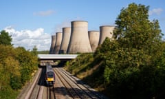 A train passes the cooling towers of Ratcliffe-on-Soar power station