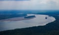 A tugboat pushing barges navigates around sandbars amid low water levels on the Mississippi River