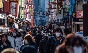 People walk past shops in the popular shopping area of Ueno in Tokyo