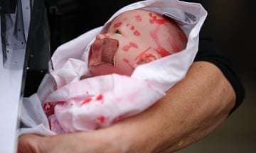 A protester holds a mock dead baby during a march in London last month.