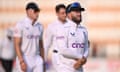 Ben Duckett leaves the field holding his left wrist and grimacing