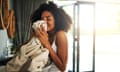 Cropped shot of an attractive young woman smelling clean laundry at home